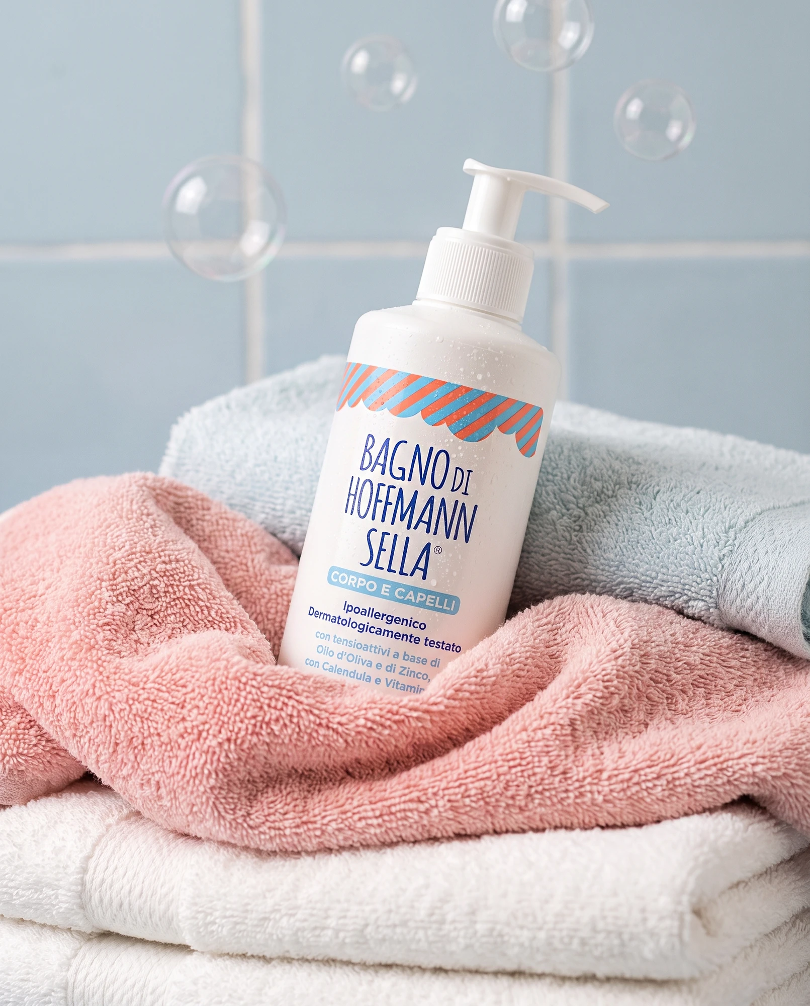 Bottle of Bagno di Hoffmann Sella body and hair wash on soft towels with soap bubbles