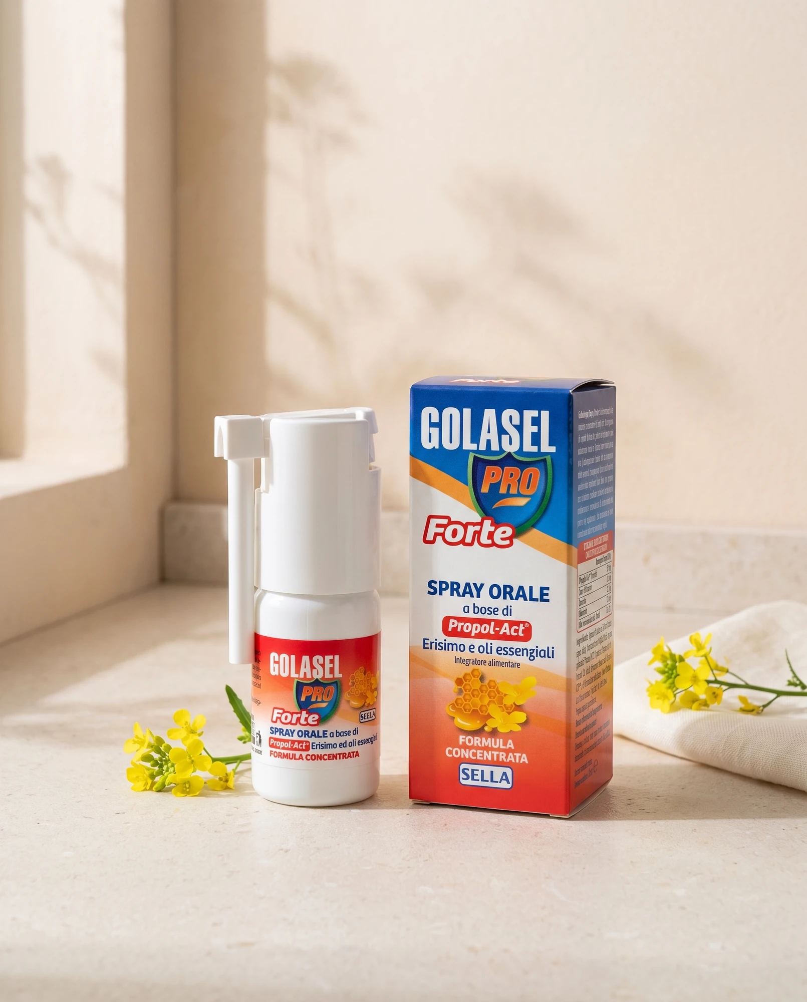 Golasel Pro Forte oral spray and pack with small yellow flowers on a light surface