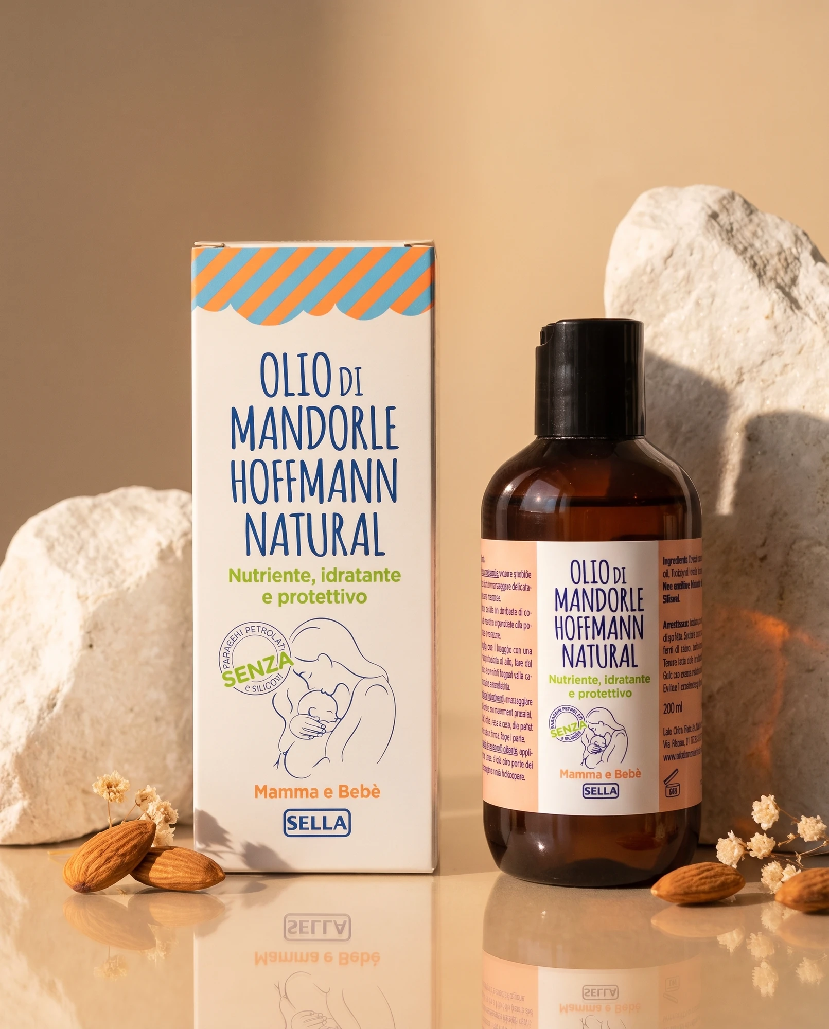 Pack and bottle of Olio di Mandorle Hoffmann Natural among white rocks and almonds against a warm-toned background